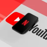 Điện thoại hiển thị logo YouTube và Netflix, thể hiện xu hướng xem giải trí đêm.