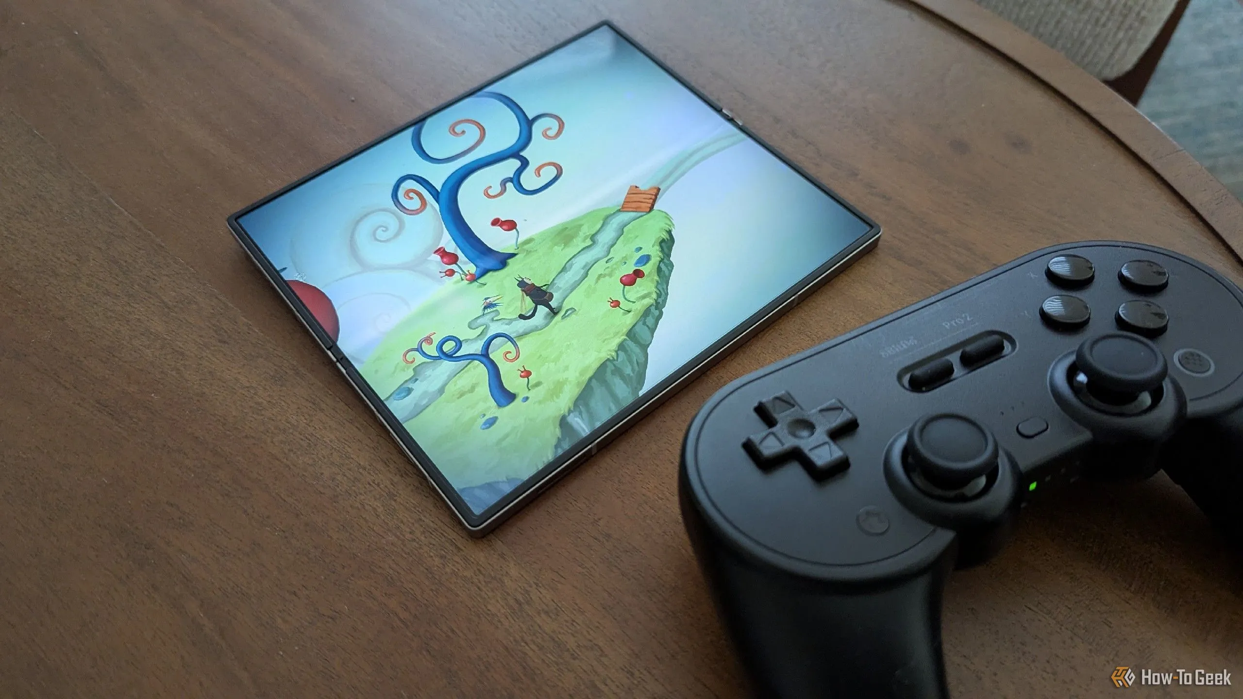Game Figment hiển thị trên Samsung Galaxy Z Fold 6 bên cạnh tay cầm Bluetooth 8BitDo Pro 2, minh họa khả năng tương thích tay cầm