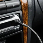 Màn hình đầu đĩa xe hơi cũ với các nút điều khiển và cổng AUX, điển hình cho hệ thống giải trí lỗi thời.