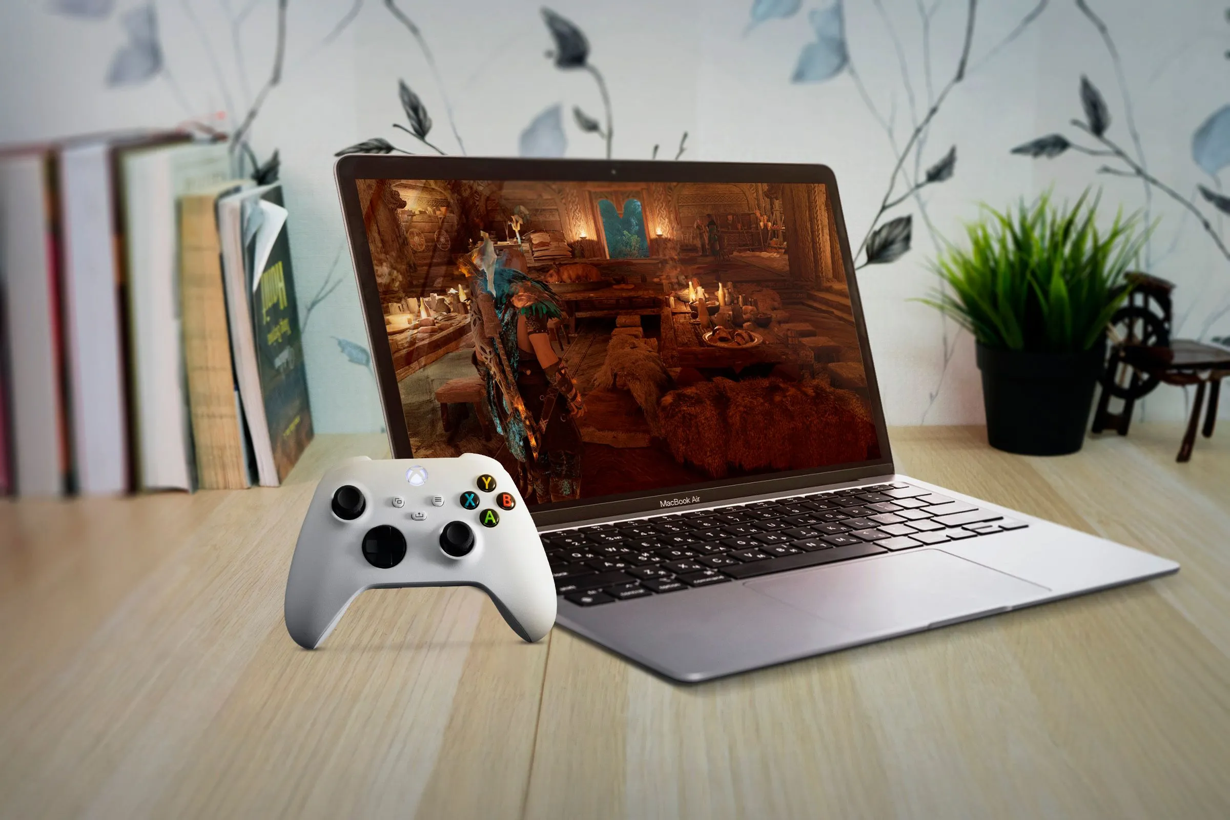 Người dùng trải nghiệm chơi game trên MacBook Air với tay cầm Xbox, thể hiện khả năng gaming cơ bản của Mac